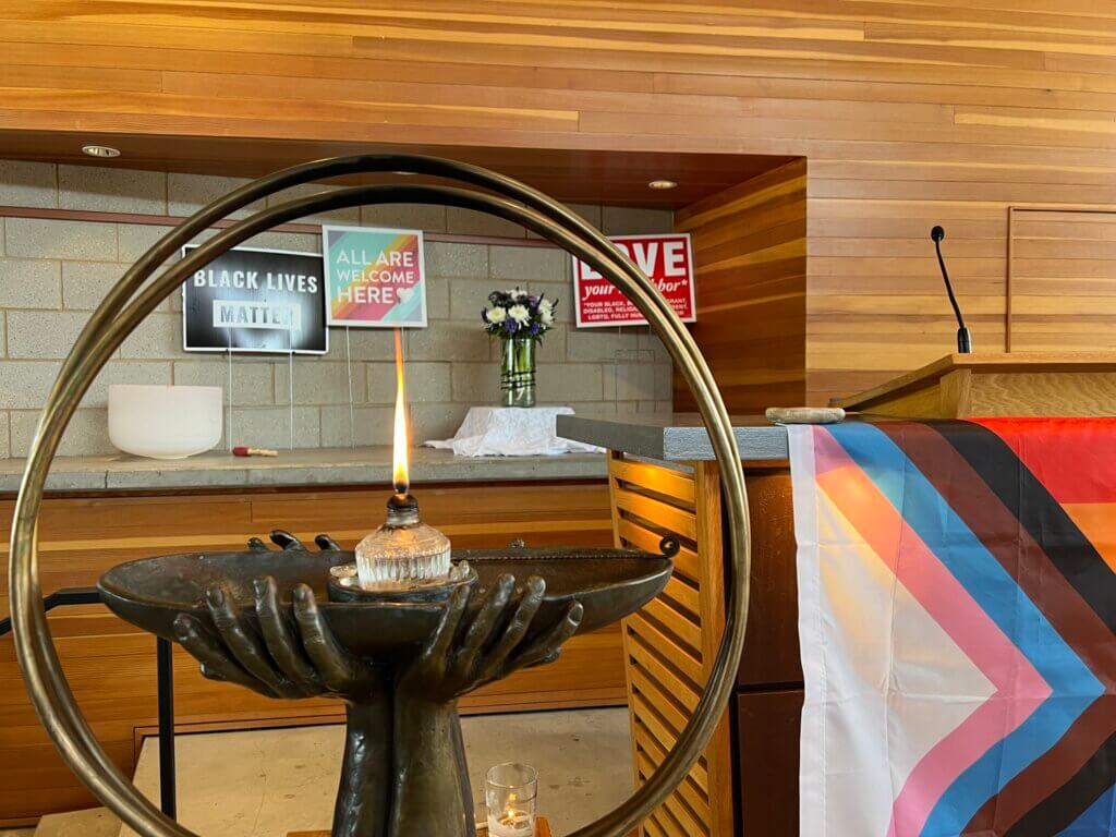 WBUUC's chalice of hands holding a flame