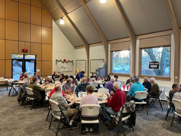 large group having a meal at tables inside